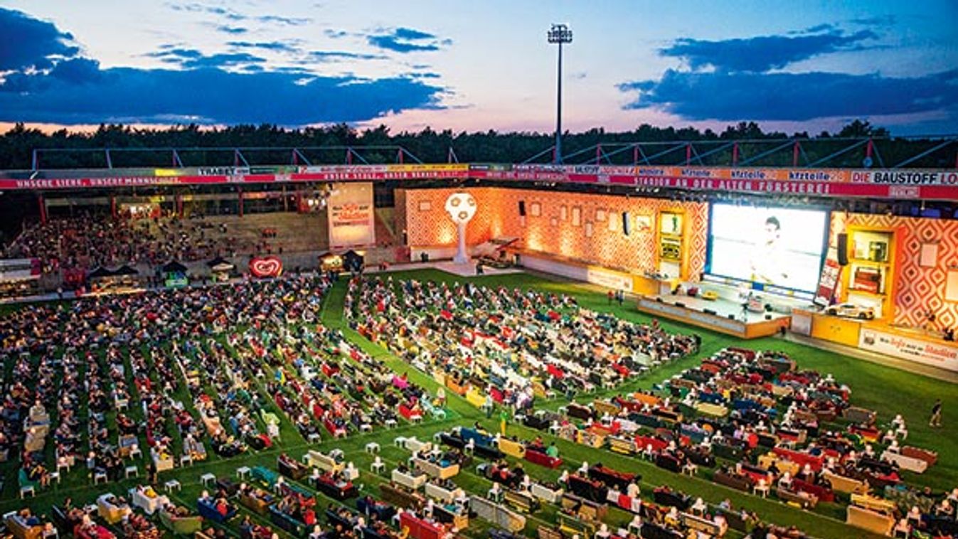 People sit on sofas as they watch the opening game of the 2014 World Cup between Brazil and Croatia, during a public viewing event in Berlin