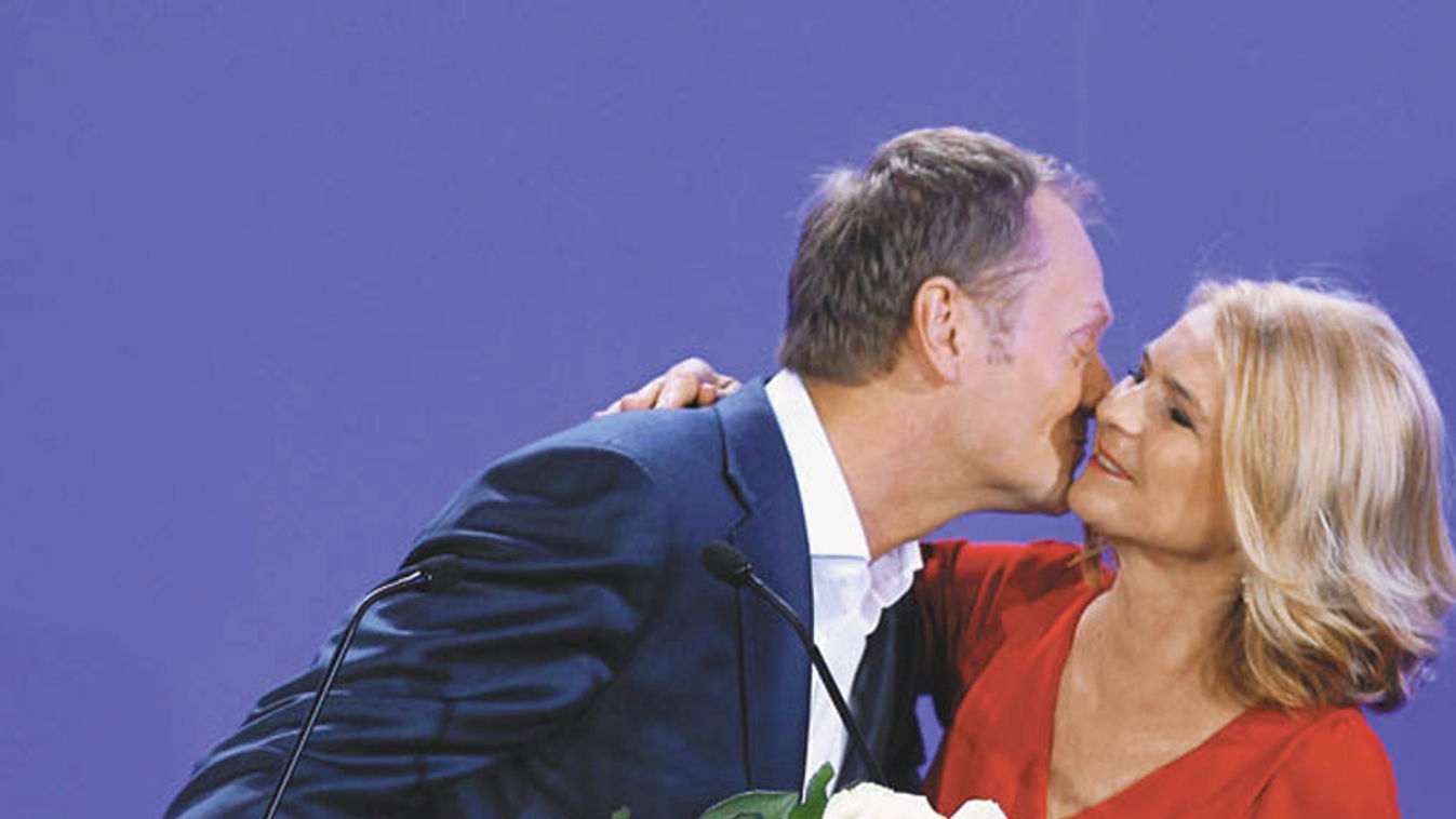 Poland's Prime Minister Tusk leader of ruling centre-right Civic Platform kisses his wife Malgorzata after the election results announcement in Warsaw