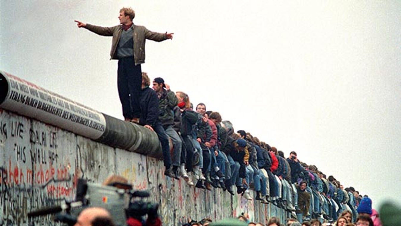 People Stand On The Berlin Wall