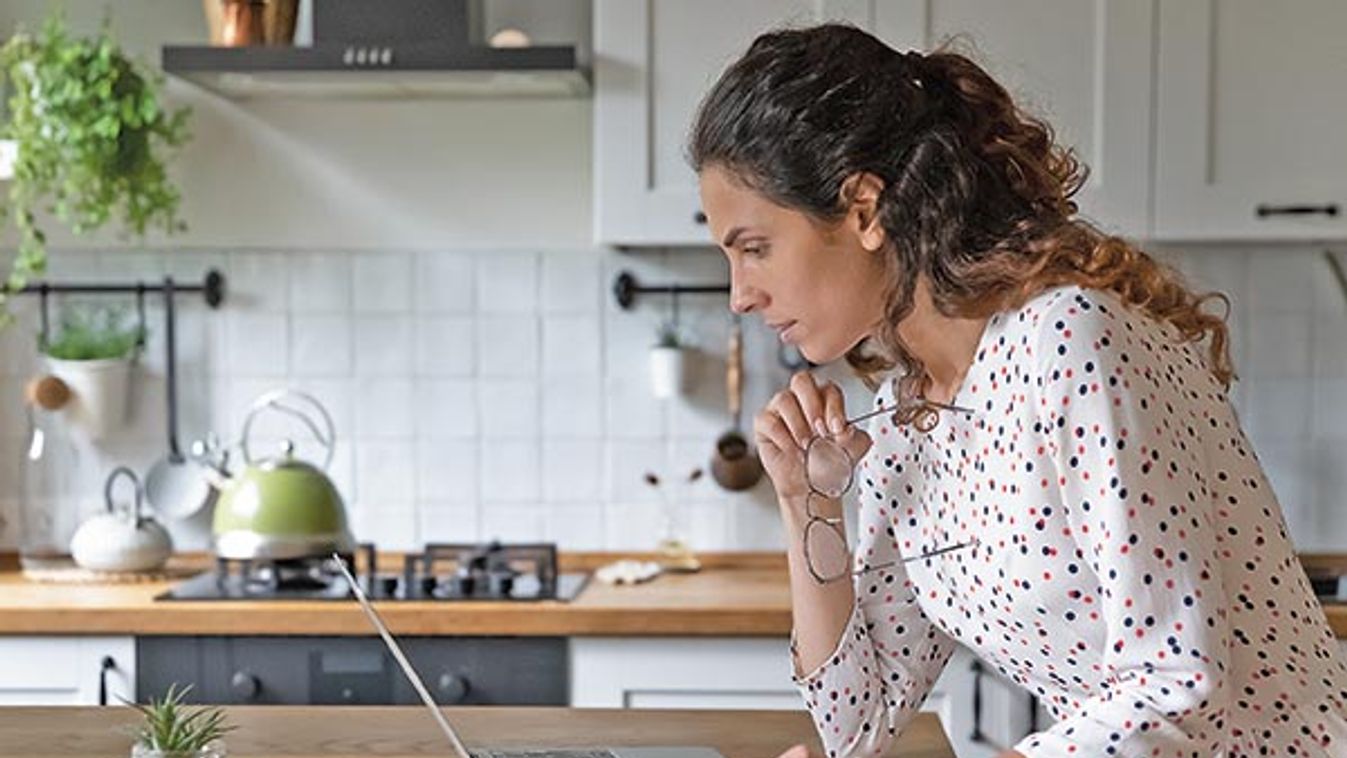 Thoughtful,Young,Caucasian,Woman,Look,At,Laptop,Screen,Busy,Calculating