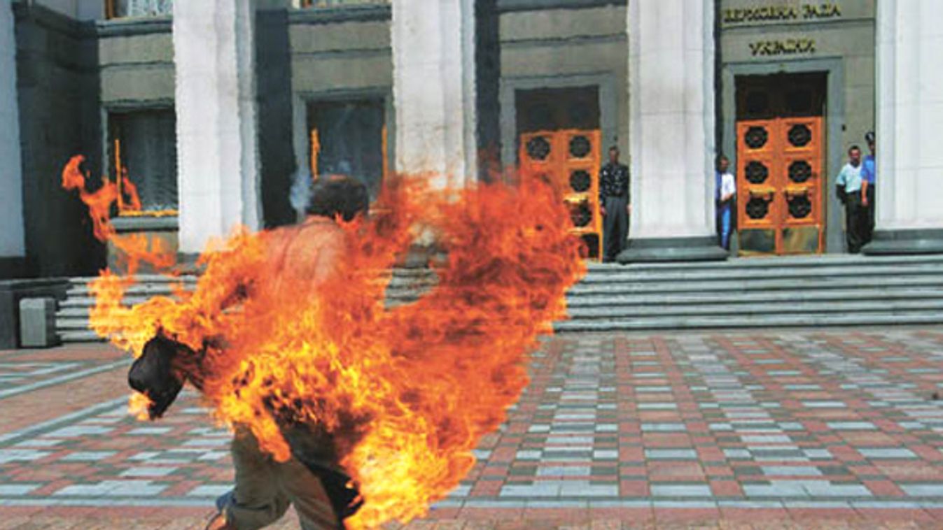 A protester sets himself on fire in front of the Ukrainian parliament building in central Kiev.