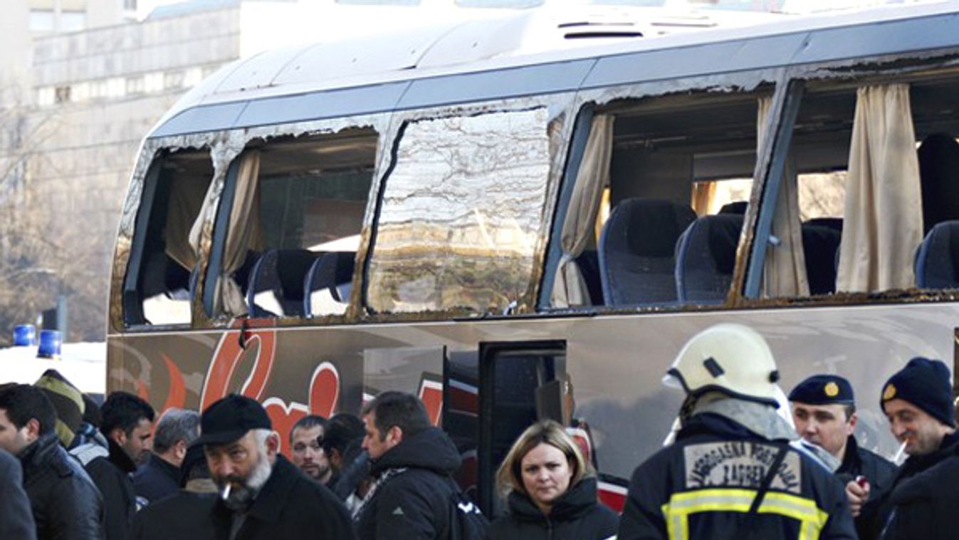 Greek soccer supporters wait in front of their damaged bus after an attack by local hooligans in the Croatian capital of Zagreb