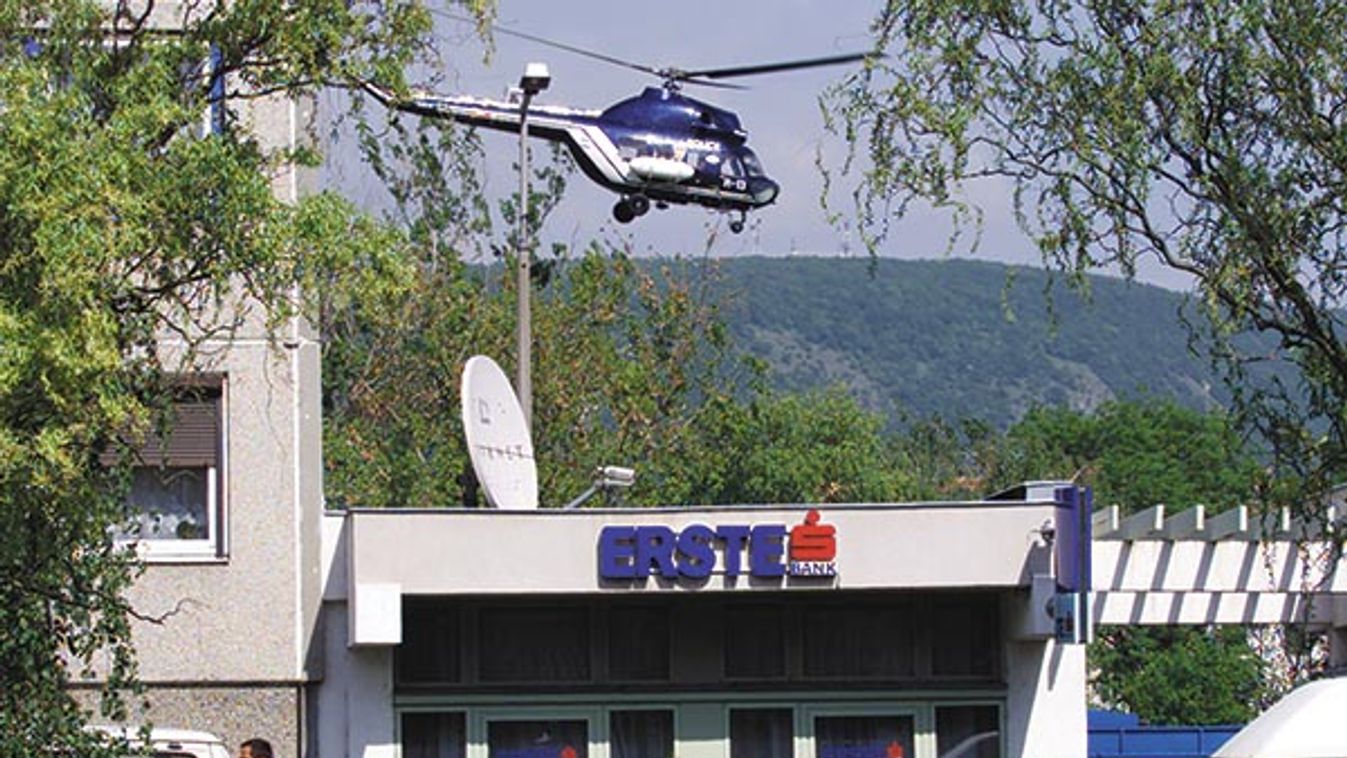 POLICE HELICOPTER CIRCLES ABOVE SCENE OF HUNGARY'S MOST VIOLENT BANK
ROBBERY.