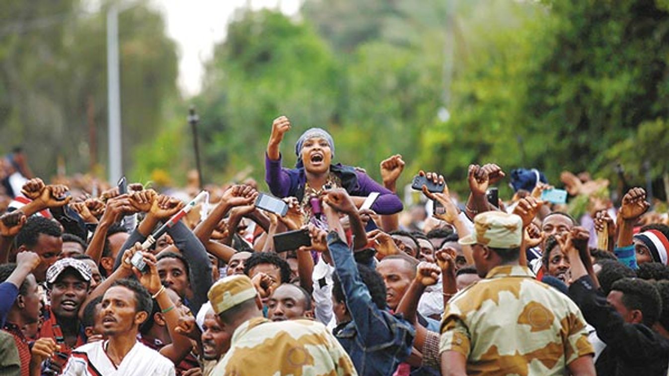 Demonstrators chant slogans while flashing the Oromo protest gesture during Irreecha, the thanksgiving festival of the Oromo people, in Bishoftu town, Oromia region, Ethiopia