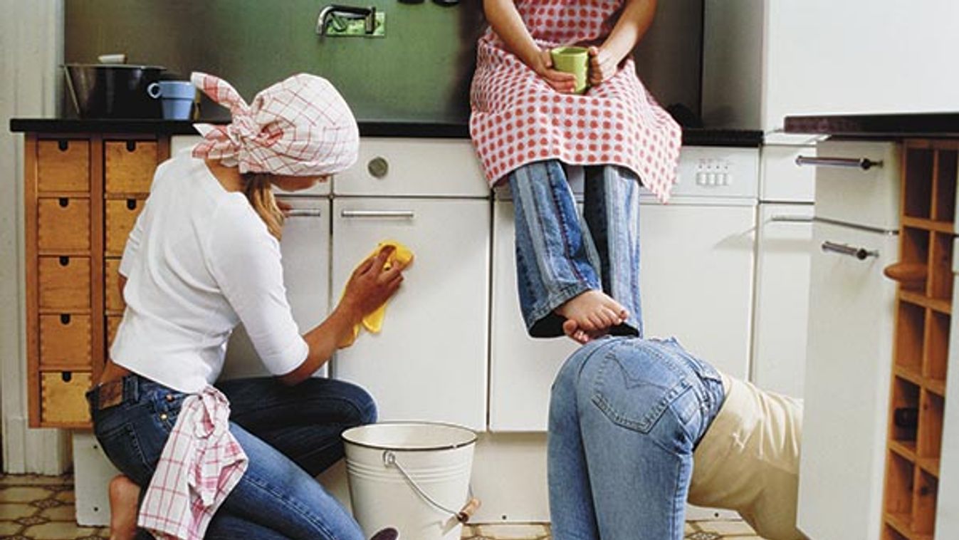 Three women cleaning the kitchen