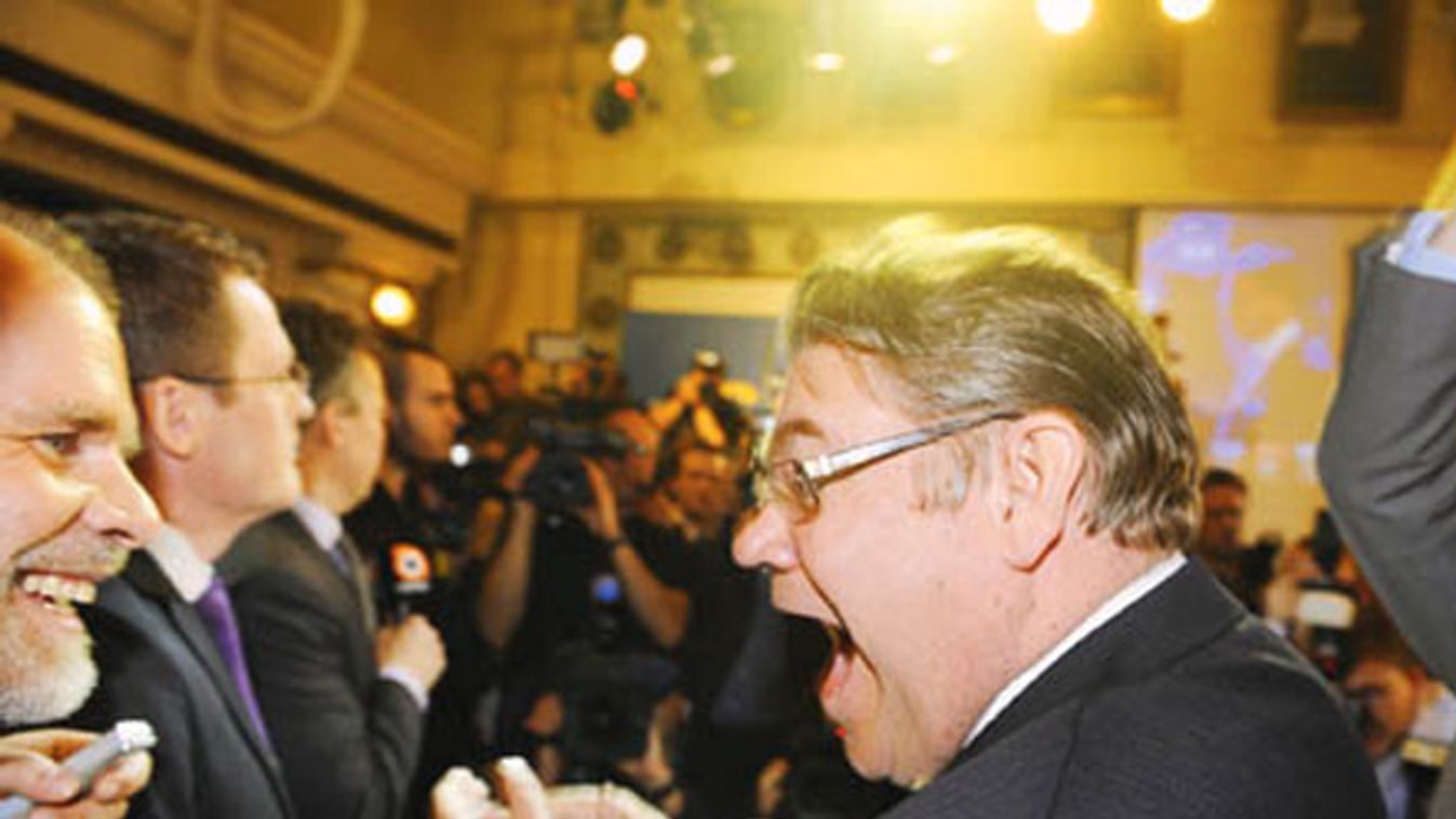 Chairman oini of True Finns celebrates with supporters after hearing the results of first preliminary votes of Finnish parliamentary elections in Helsinki