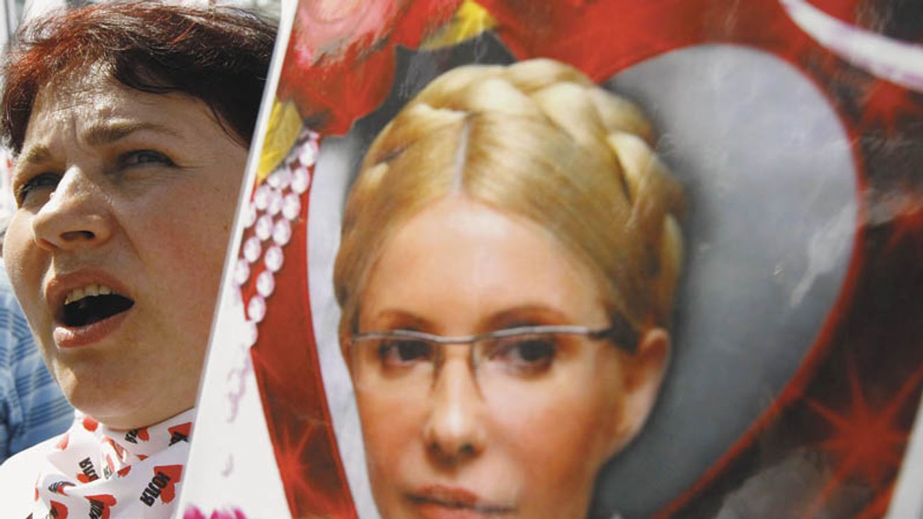 A supporter of opposition leader and former Ukrainian PM Tymoshenko holds her portrait during a rally in Kiev