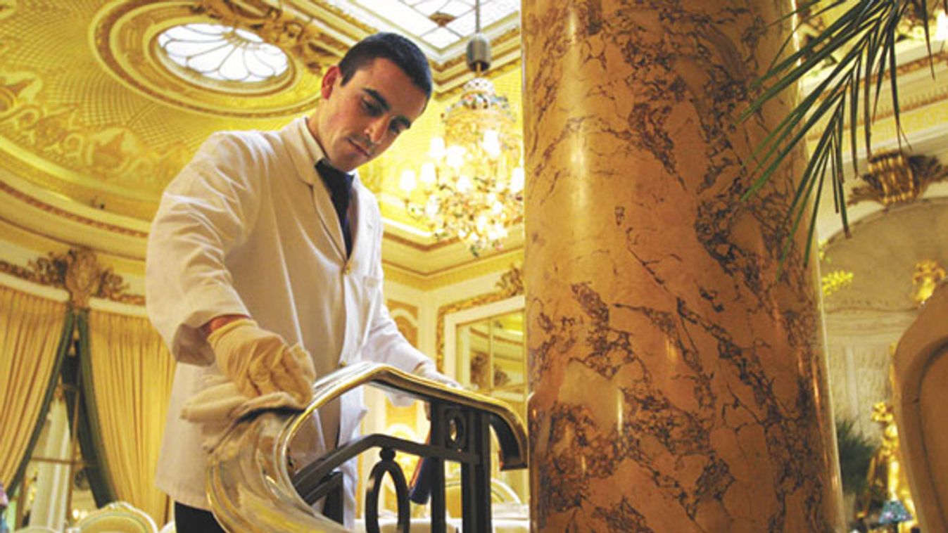 The Ritz hotel's employee of the year polishes a handrail in London