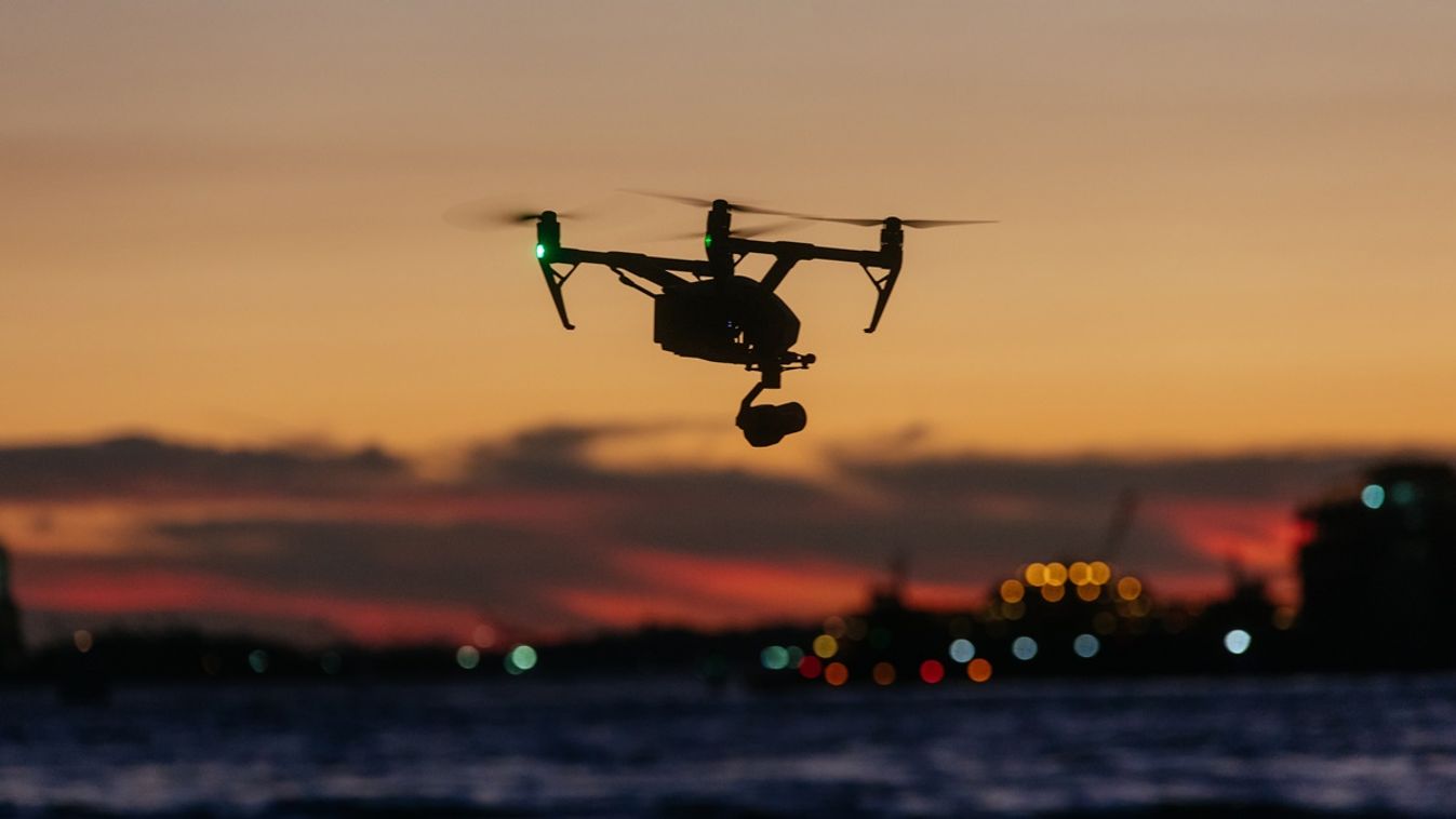 Drone flying and taking pictures of sunset against new york skyline