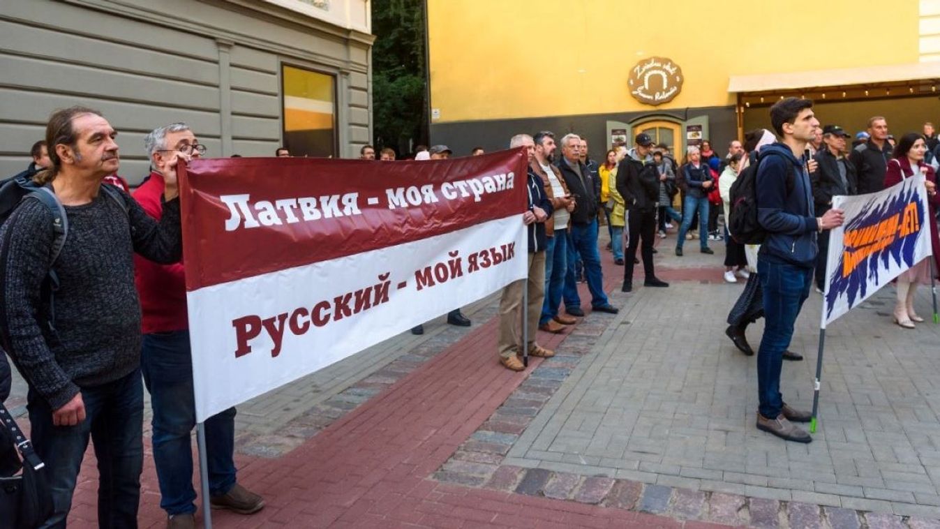 People hold up a banner which reads "Latvia my country. Russian - my language" at the Latvian-Russian Union protest against the minority schools' transition to full Latvian language learning on September 7, 2022 in Riga, Latvia.