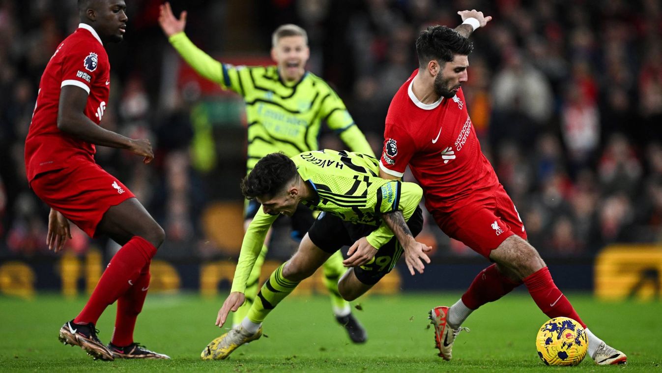 Arsenal's German midfielder #29 Kai Havertz (L) is tackled by Liverpool's Hungarian midfielder #08 Dominik Szoboszlai (R) as they fight for the ball during the English Premier League football match between Liverpool and Arsenal at Anfield in Liverpool, north west England on December 23, 2023.