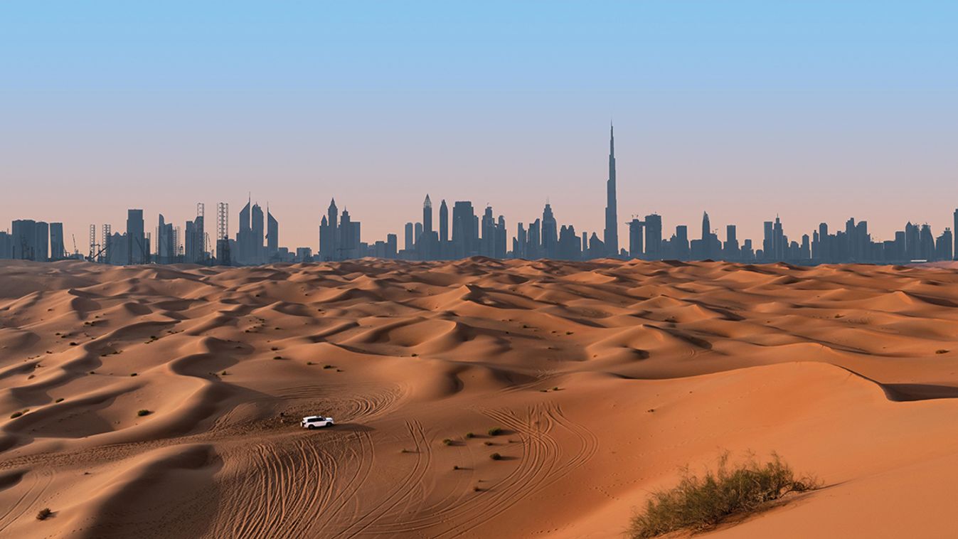 Dubai,Skyline,On,The,Horizon,Of,A,Sand,And,Dune