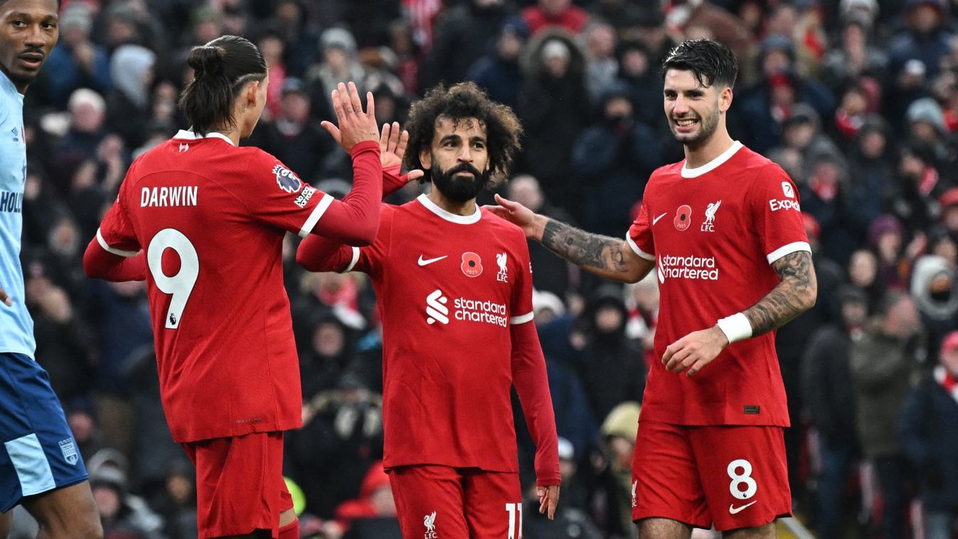 Liverpool's Egyptian striker #11 Mohamed Salah (C) is congratulated after scoring their second goal during the English Premier League football match between Liverpool and Brentford at Anfield in Liverpool, north west England on November 12, 2023.