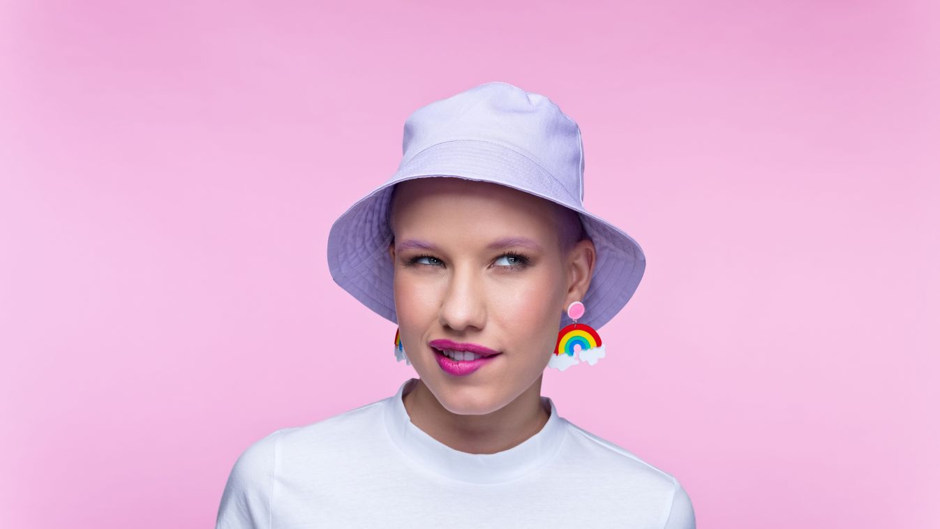 Headshot of woman with rainbow earrings