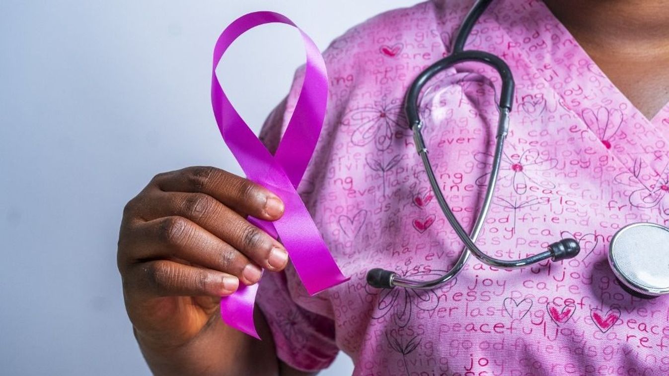 Doctor holding a breast cancer awareness ribbon
