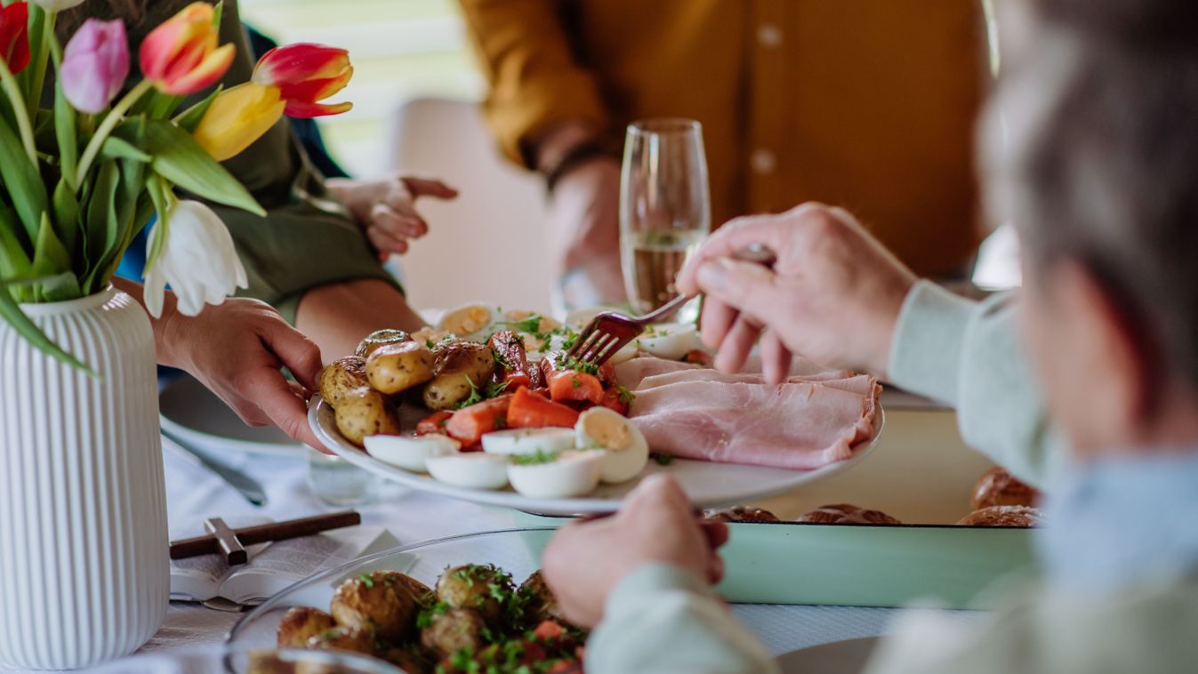 Close,Up,Of,Muligenerational,Family,Serving,Easter,Dinner,Together.