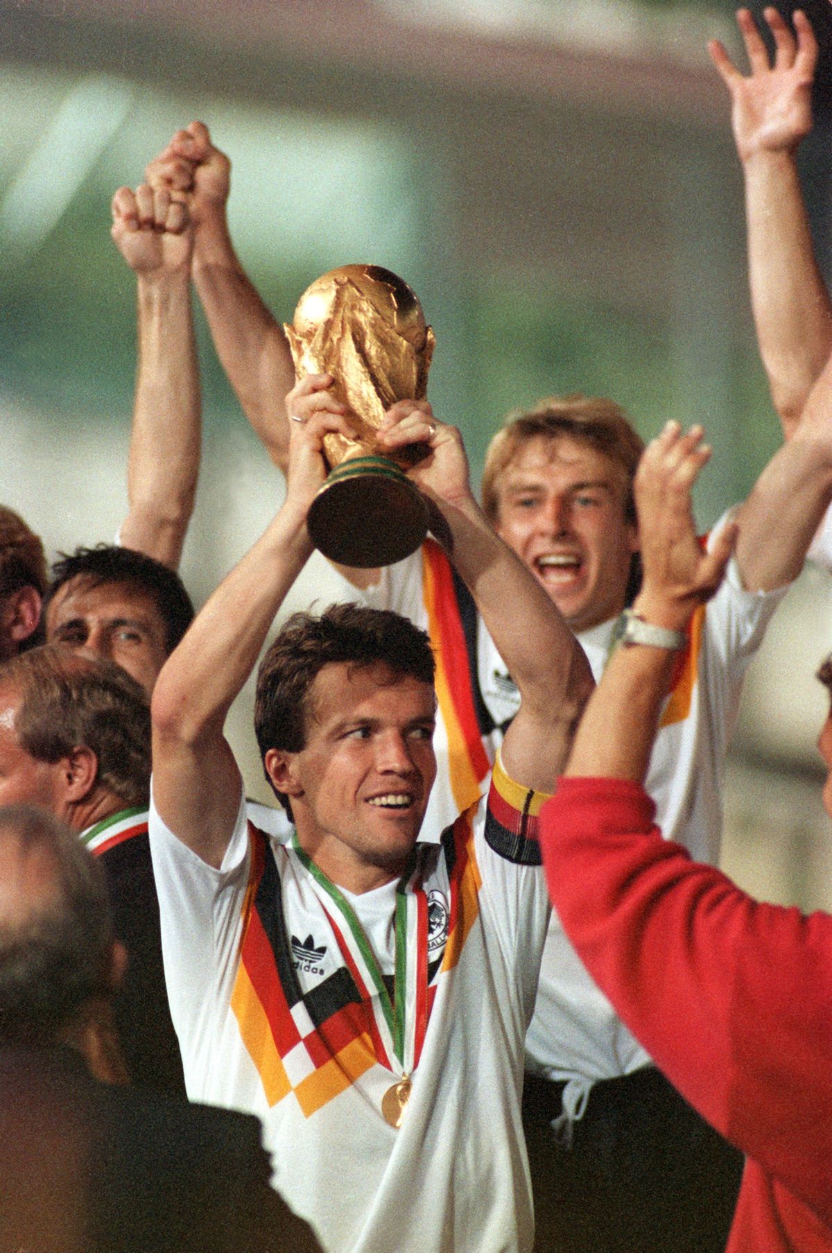 Soccer World Cup 1990: Lothar MatthaeusSoccer World Cup 1990: Lothar MatthaeusGerman team captain Lothar Matthaeus lifts up the World Cup triumphantly at the presentation ceremony for his team at Olympic Stadium in Rome, Italy on 08 July 1990. Behind him can be seen goalgetter Juergen Klinsmann (R). The German national soccer team had just won the World Cup final against Argentina by a score of 1-0.


Keywords: Sport, SPO, Sport, SPO, People, soccer, male, smiling, trophy, cheering, celebrating (Photo by FRANK KLEEFELDT / DPA / dpa Picture-Alliance via AFP)Soccer World Cup 1990: Lothar MatthaeusSoccer World Cup 1990: Lothar Matthaeus
