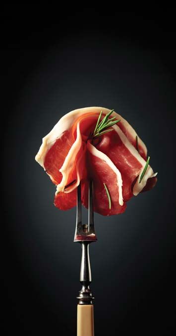 Sliced,Prosciutto,With,Rosemary,On,A,Fork.