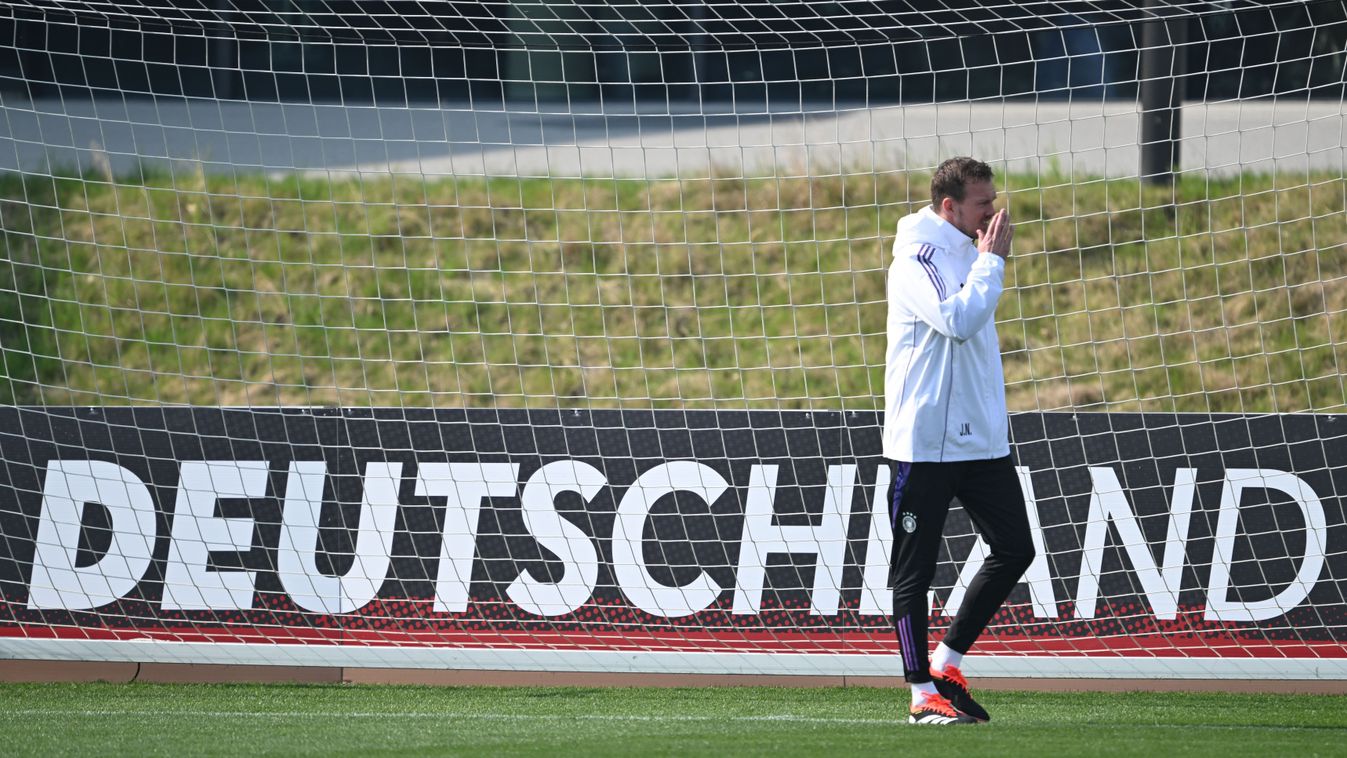 21 March 2024, Hesse, Frankfurt/Main: Soccer: National team, before the international match against France, training, DFB Campus. National team coach Julian Nagelsmann arrives on the pitch for training. Photo: Arne Dedert/dpa - IMPORTANT NOTE: In accordance with the regulations of the DFL German Football League and the DFB German Football Association, it is prohibited to utilize or have utilized photographs taken in the stadium and/or of the match in the form of sequential images and/or video-like photo series. (Photo by ARNE DEDERT / DPA / dpa Picture-Alliance via AFP)
