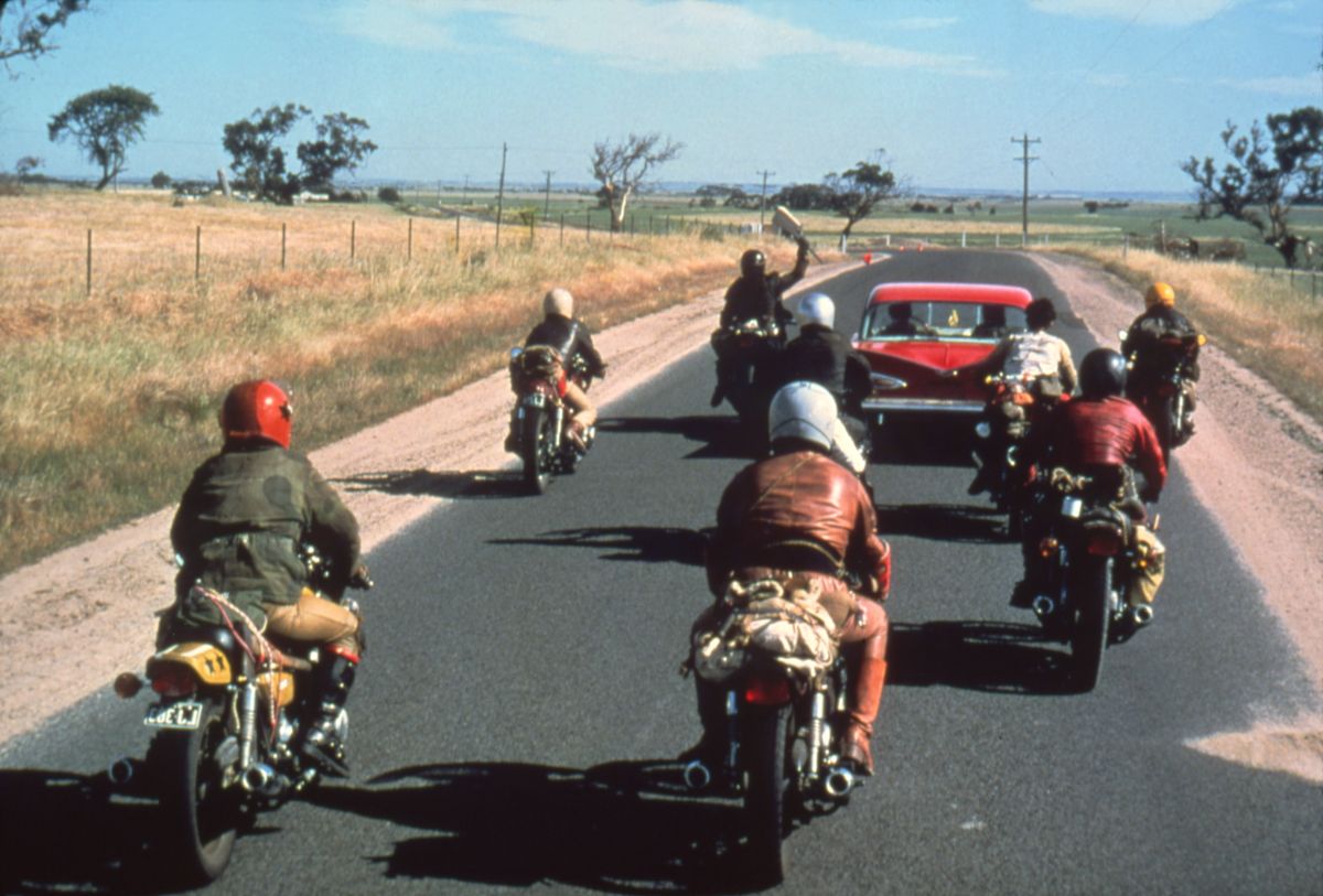 Motorcycle gang chasing car in Mad Max
