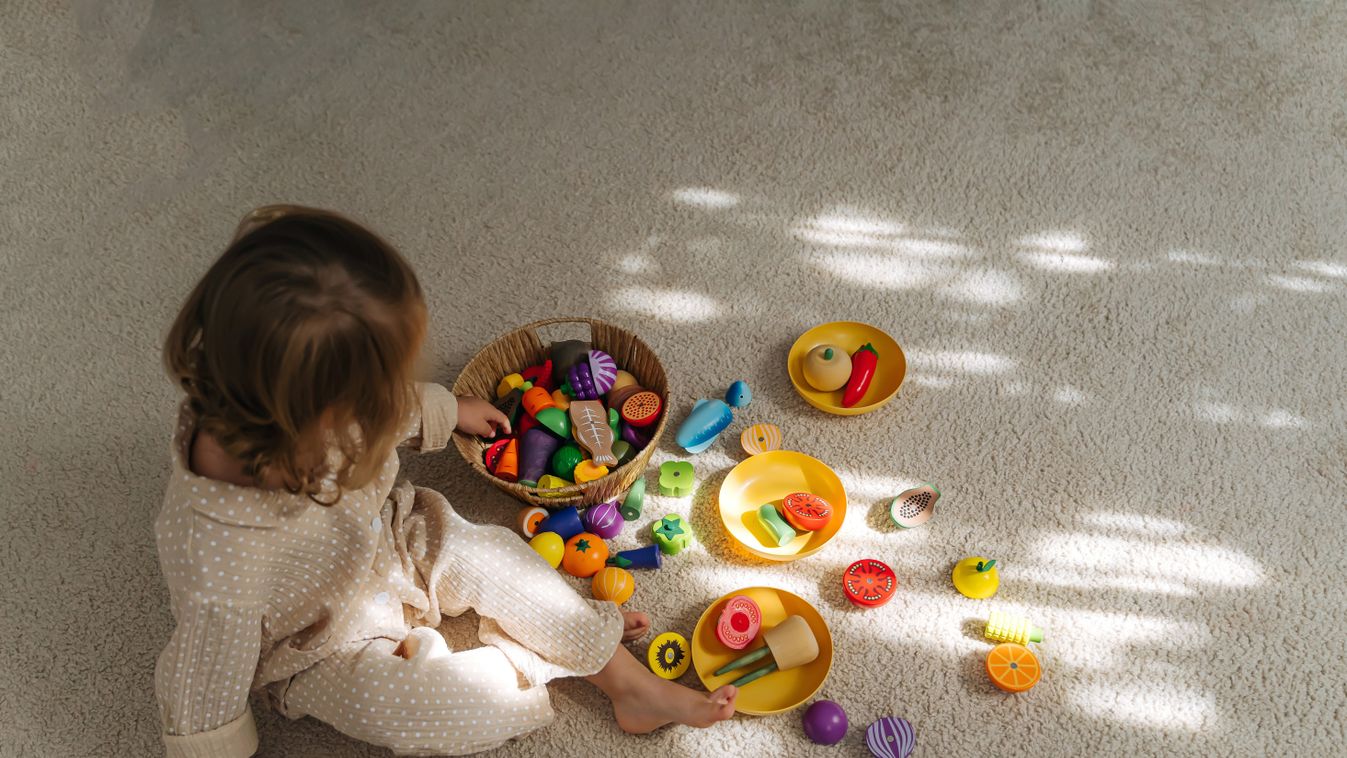 A,Little,Girl,Playing,With,Wooden,Fruits,And,Vegetables,On