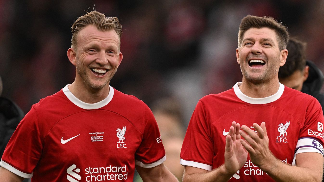 Liverpool Legends' midfielder Steven Gerrard (R) and Liverpool Legends' striker Dirk Kuyt applauds the fans following during the Legends football match between Liverpool Legends and Ajax Legends at Anfield in Liverpool, north-west England on March 23, 2024. (Photo by Oli SCARFF / AFP)