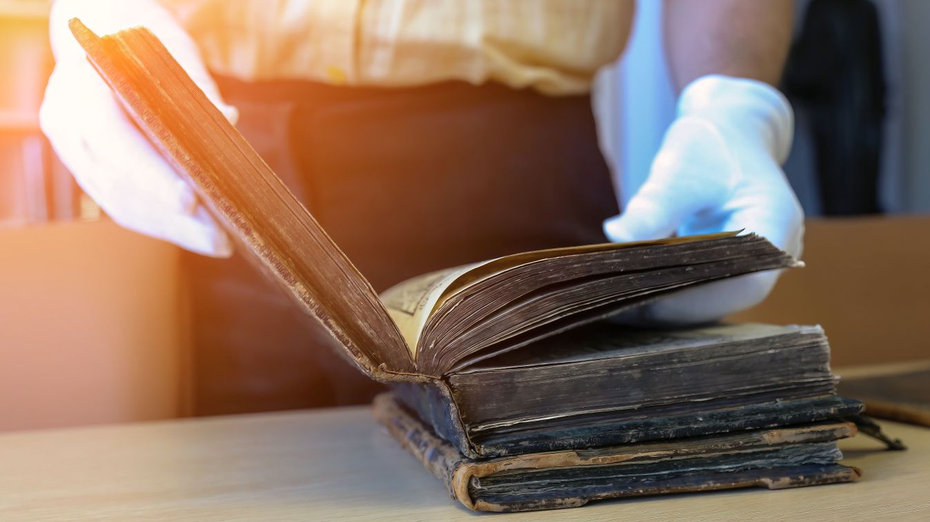 An,Old,Book,In,The,Hands,Of,A,Scientist,,Close-up.