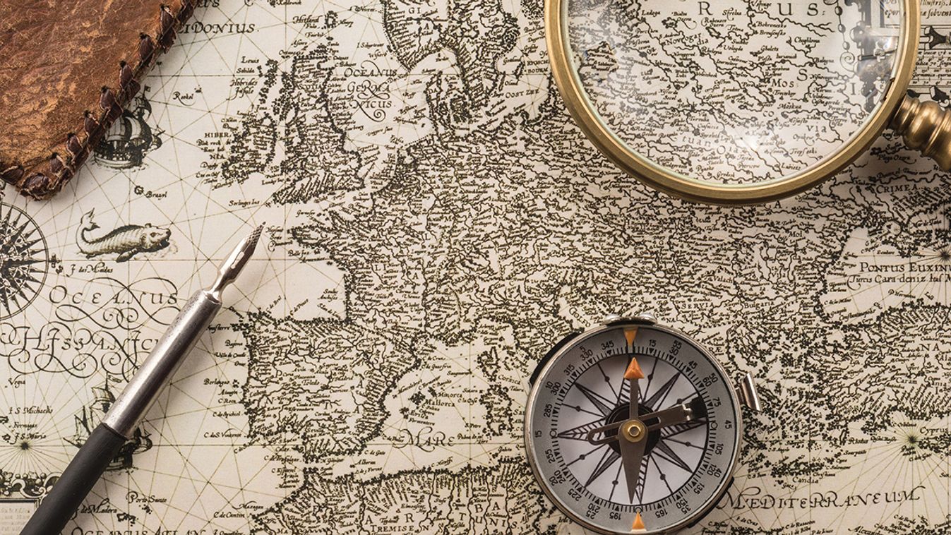 Compass,,Ink,Pen,,Magnifier,And,Folder,On,Vintage,Map