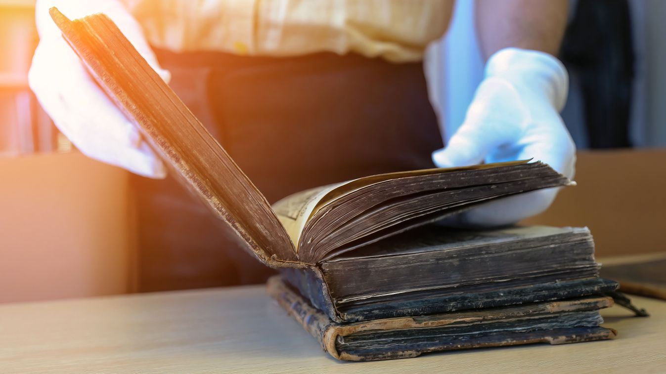 An,Old,Book,In,The,Hands,Of,A,Scientist,,Close-up.