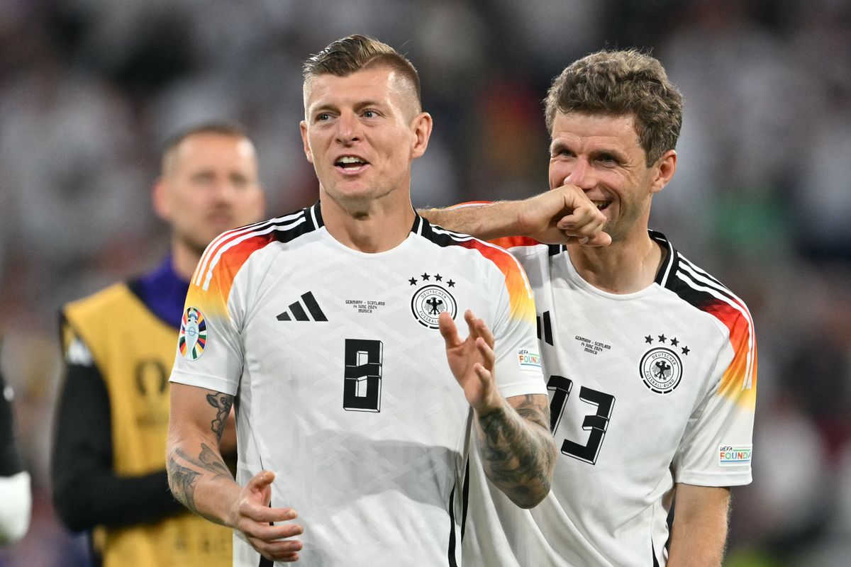 Germany's midfielder #08 Toni Kroos and Germany's forward #13 Thomas Mueller celebrate after winning the UEFA Euro 2024 Group A football match between Germany and Scotland at the Munich Football Arena in Munich on June 14, 2024.