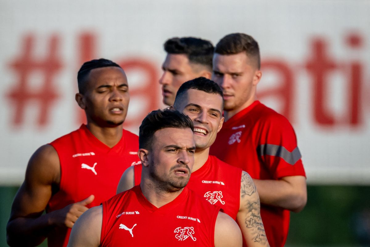 (From L to R) Switzerland's defender Manuel Akanji, midfielder Xherdan Shaqiri, midfielder Granit Xhaka, defender Fabian Schaer and defender Nico Elvedi warm up during a training session at the University of Doha for Science and Technology training facilities in Doha on November 15, 2022, ahead of the Qatar 2022 World Cup football tournament. 