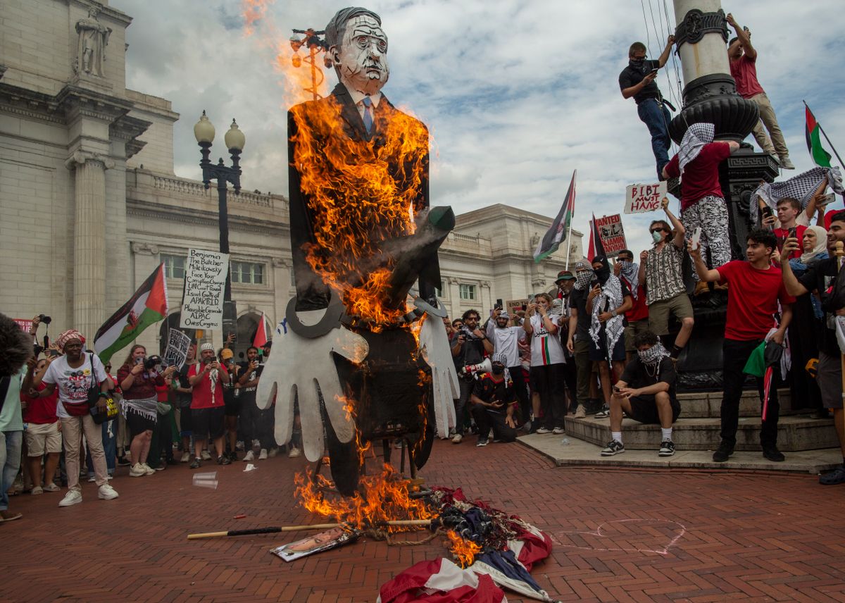 Pro-Palestinian demonstrators burn a US flag and a puppet of