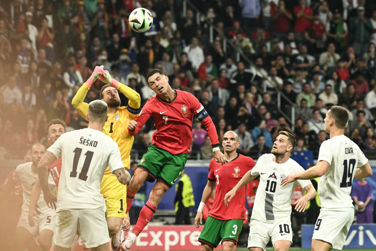 Portugal's forward #07 Cristiano Ronaldo heads the ball past Slovenia's goalkeeper #01 Jan Oblak during the UEFA Euro 2024 round of 16 football match between Portugal and Slovenia at the Frankfurt Arena in Frankfurt am Main on July 1, 2024. 
