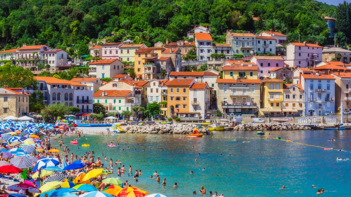 People enjoying at beach by Opatija town during summer