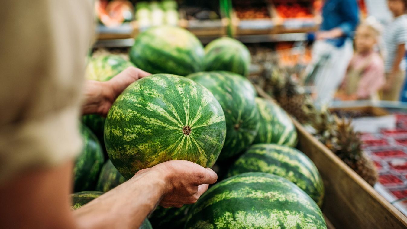 Partial,View,Of,Woman,Picking,Watermelon,In,Grocery,Shop