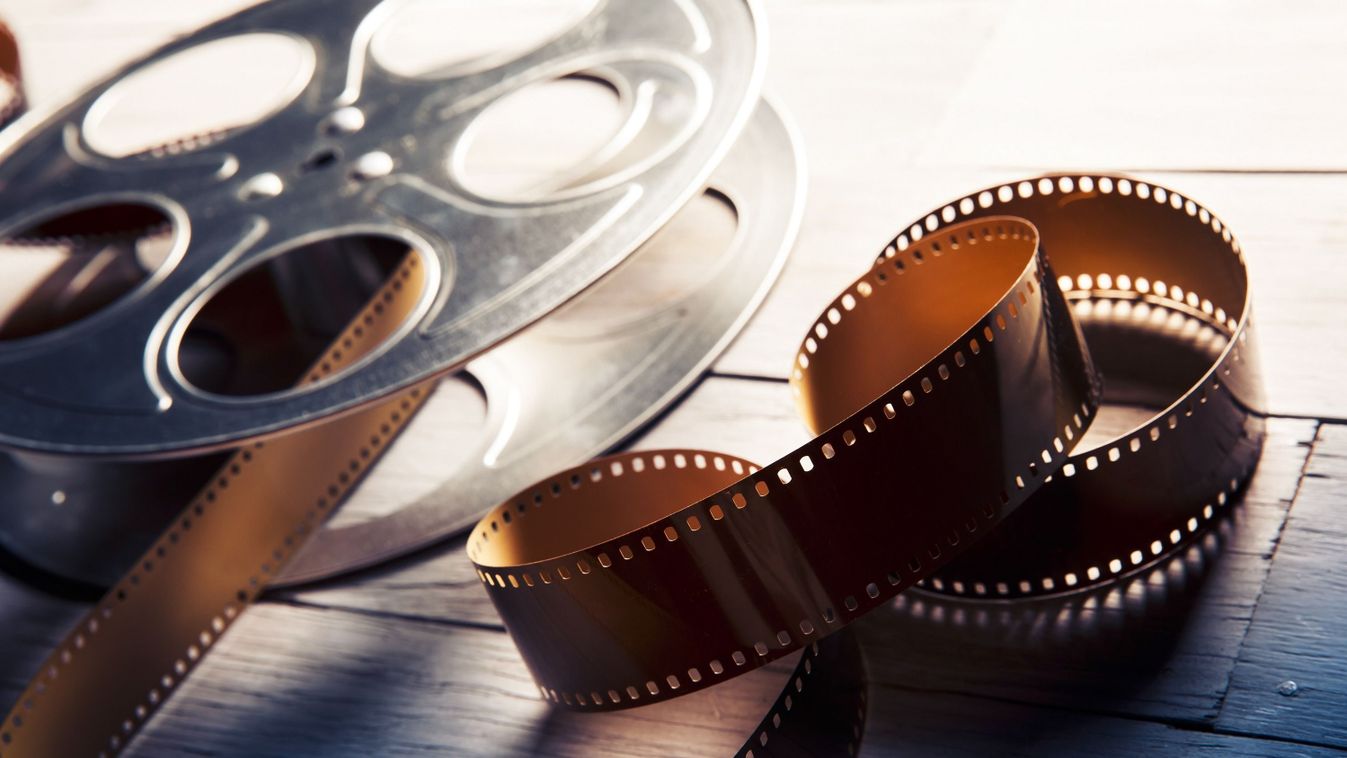 Movie,Reel,On,A,Wooden,Background