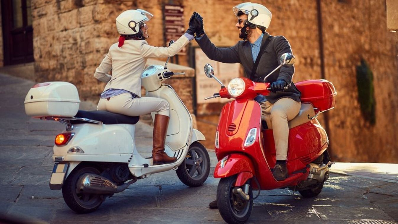 Young,Italian,Couple,On,Vespa,Scooter.,Bikers,Couple.