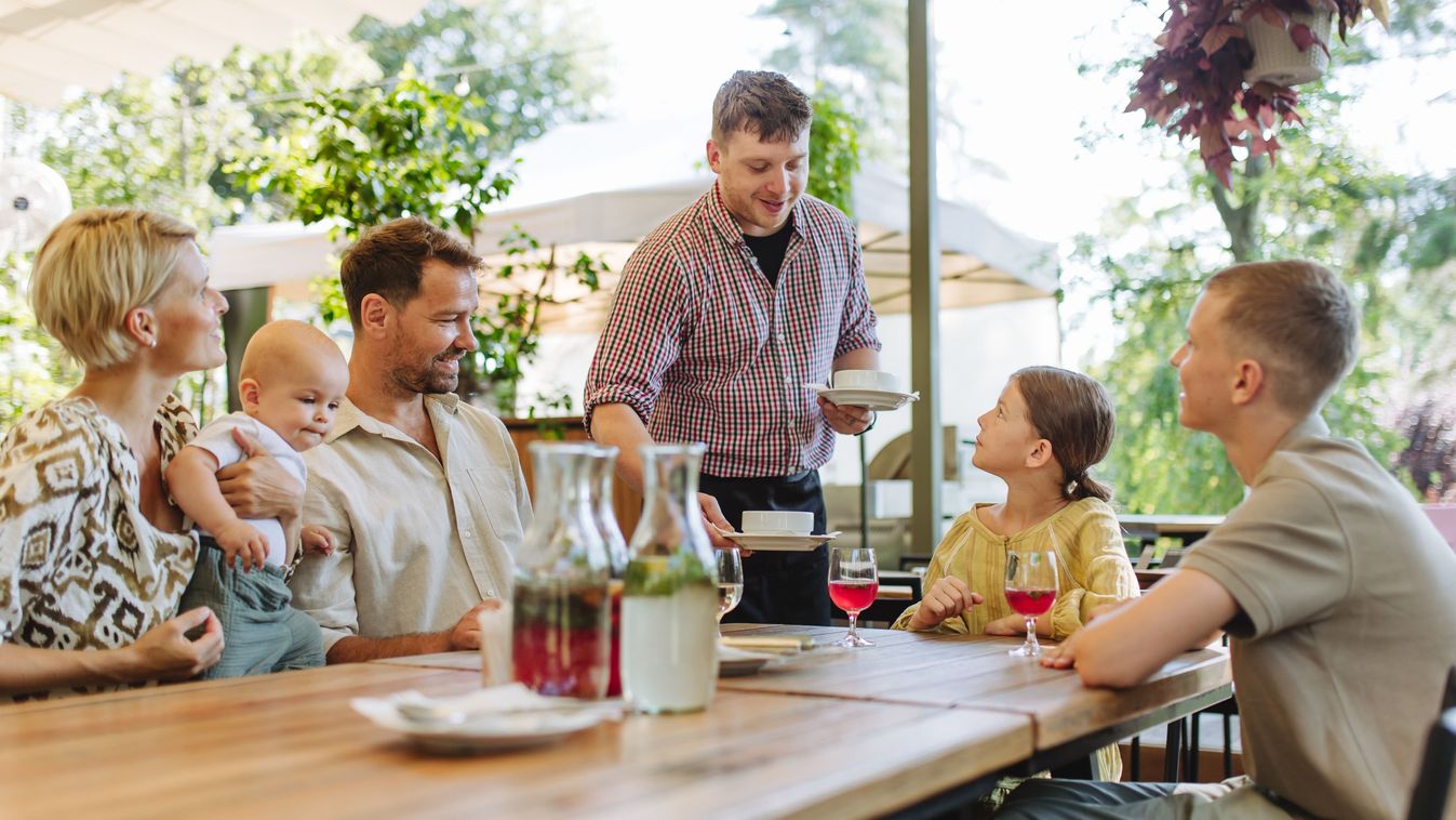 Waiter,Bringing,Food,To,The,Table,In,The,Restaurant.