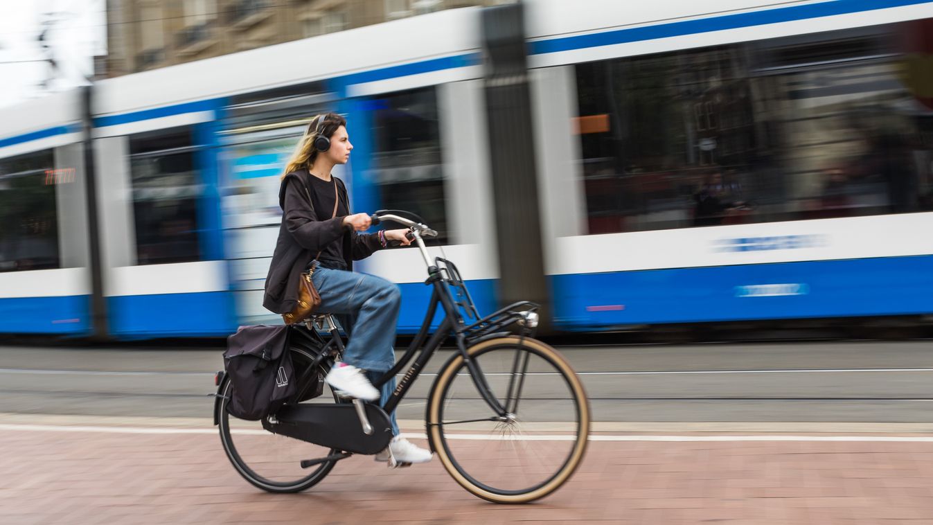 A,Lady,On,Her,Bike,Is,Overtaken,By,A,Tram