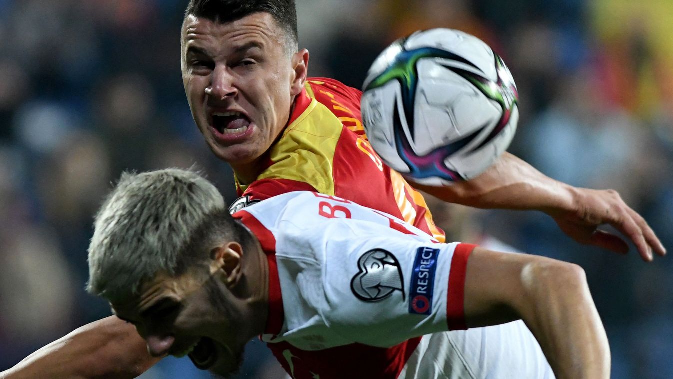 Turkey's Berat Ozdemir (L) fights for the ball with Montenegro's Milutin Osmajic (R) during the FIFA World Cup Qatar 2022 qualification group G football match between Montenegro and Turkey at the Podgorica's City Stadium on November 16, 2021.  