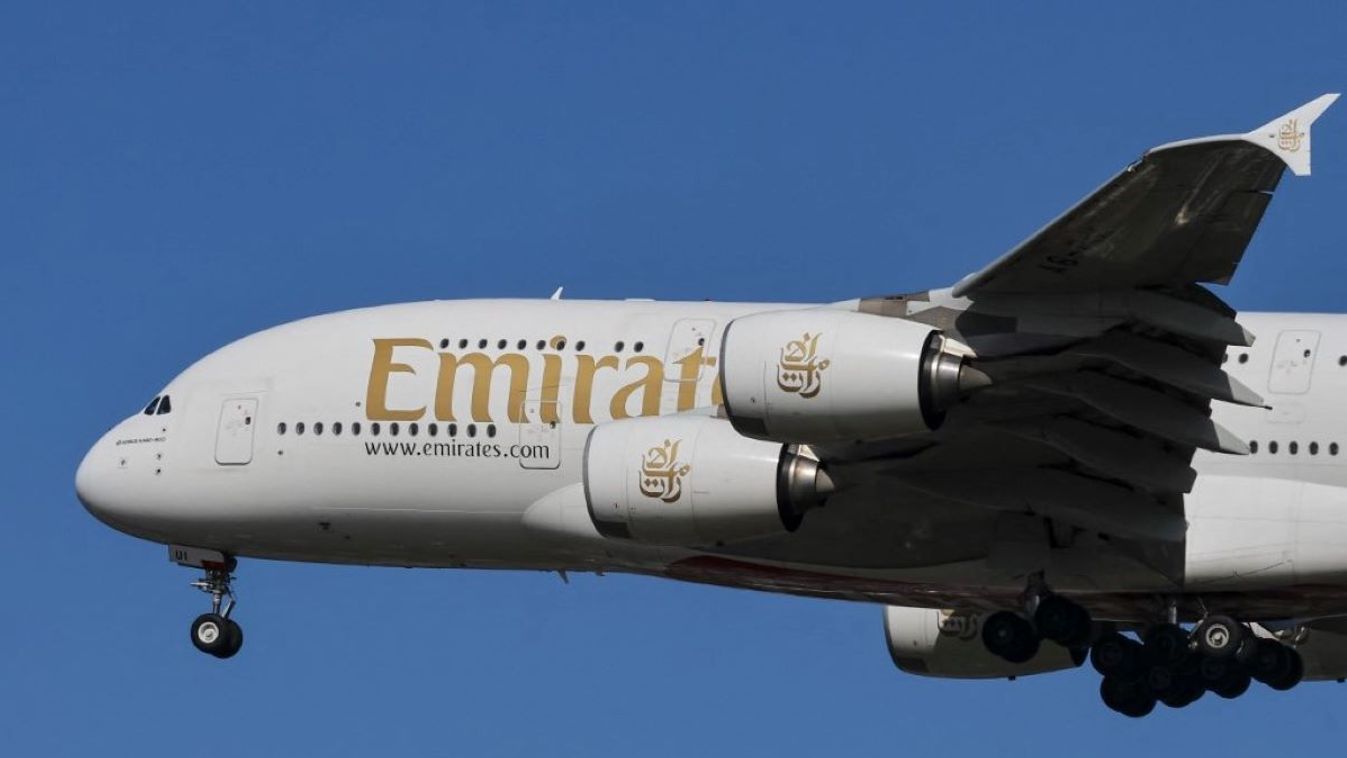 Emirates Airbus A380 double decker passenger aircraft spotted flying in the air between the blue sky and the clouds, on final approach for landing on the runway of London Heathrow Airport LHR in the United Kingdom.