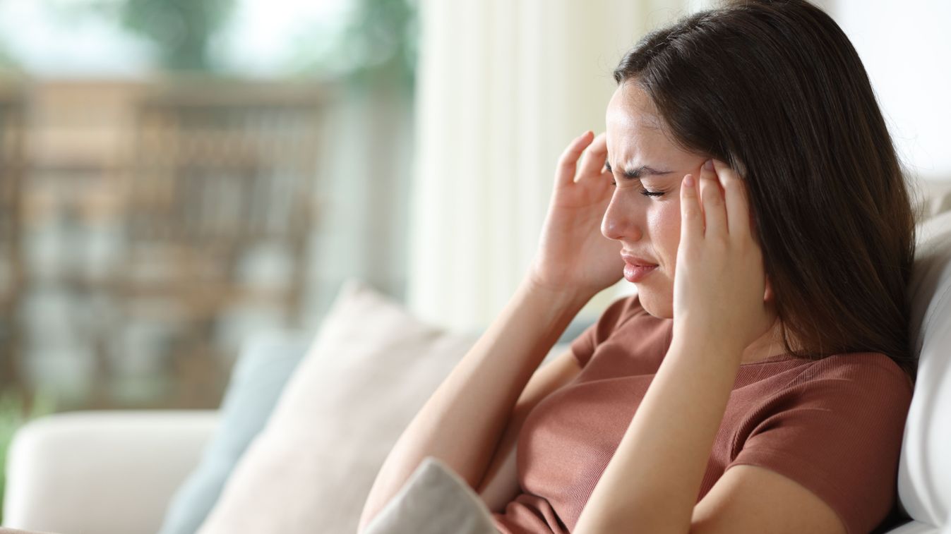 Stressed,Woman,Suffering,Migraine,And,Complaining,Sitting,On,A,Couch