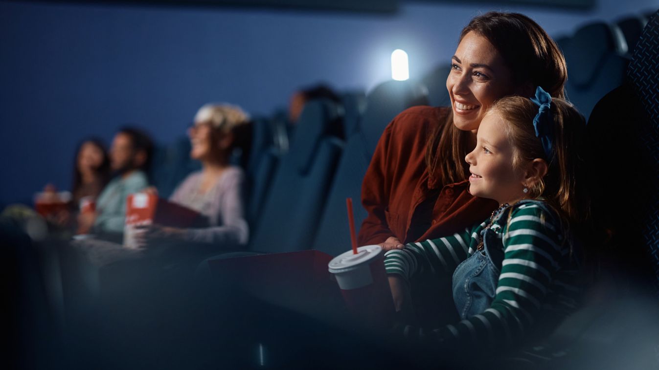 Happy,Little,Girl,And,Her,Mother,Watching,Movie,In,Cinema.