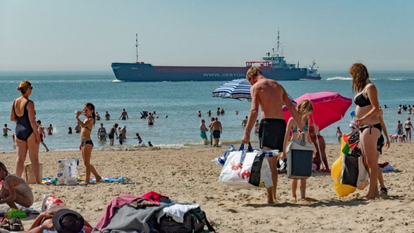 Daily life with people enjoying the summer sun at Vlissingen beach in Zeeland, The Netherlands on 25 August 2019. The 4-kilometer long beach has golden sand and people enjoy their holidays at the shore, swimming or with watersports. 