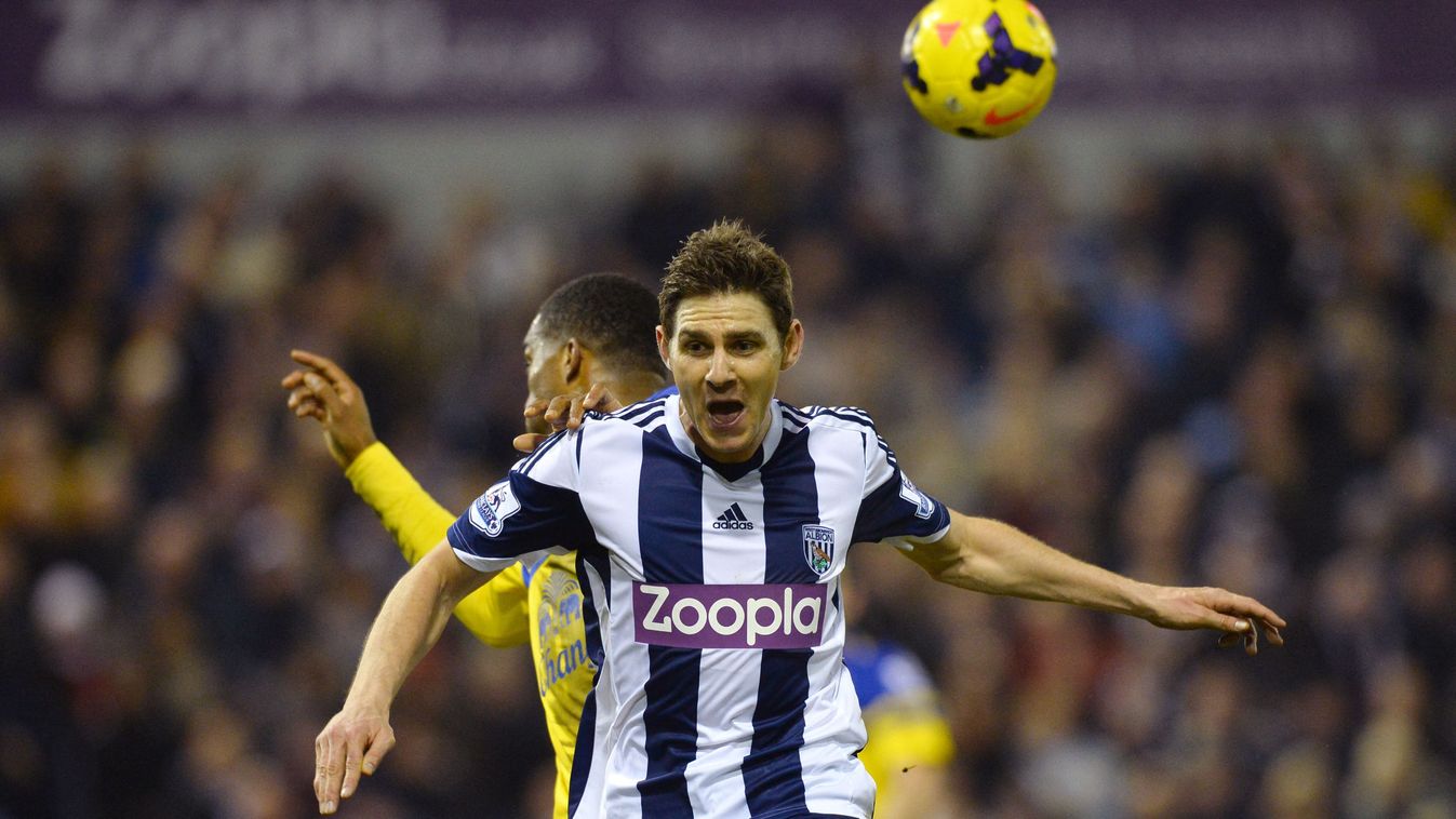 Everton's French defender Sylvain Distin (back) jumps for the ball with West Bromwich Albion's Hungarian striker Zoltan Gera during the English Premier League football match between West Bromwich Albion and Everton at the Hawthorns in West Bromwich on January 20, 2014. AFP PHOTO / PAUL ELLIS 

RESTRICTED TO EDITORIAL USE. No use with unauthorized audio, video, data, fixture lists, club/league logos or “live” services. Online in-match use limited to 45 images, no video emulation. No use in betting, games or single club/league/player publications. 