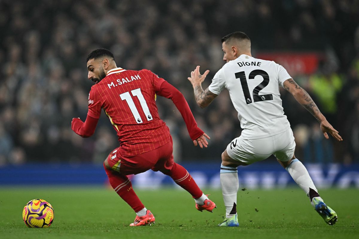 Liverpool's Egyptian striker #11 Mohamed Salah (L) vies with Aston Villa's French defender #12 Lucas Digne (R) during the English Premier League football match between Liverpool and Aston Villa at Anfield in Liverpool, north west England on November 9, 2024. 