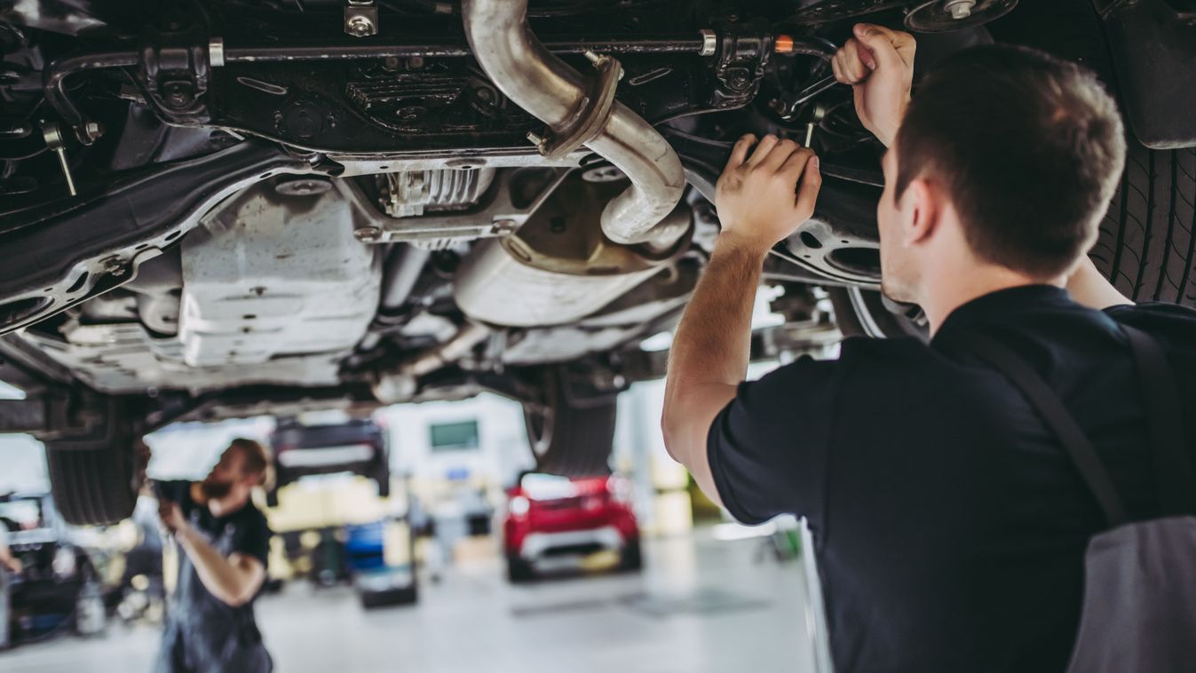 Two,Handsome,Mechanics,In,Uniform,Are,Working,In,Auto,Service