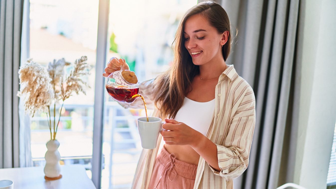 Happy,Young,Cute,Joyful,Smiling,Satisfied,Woman,Pouring,Hot,Tea