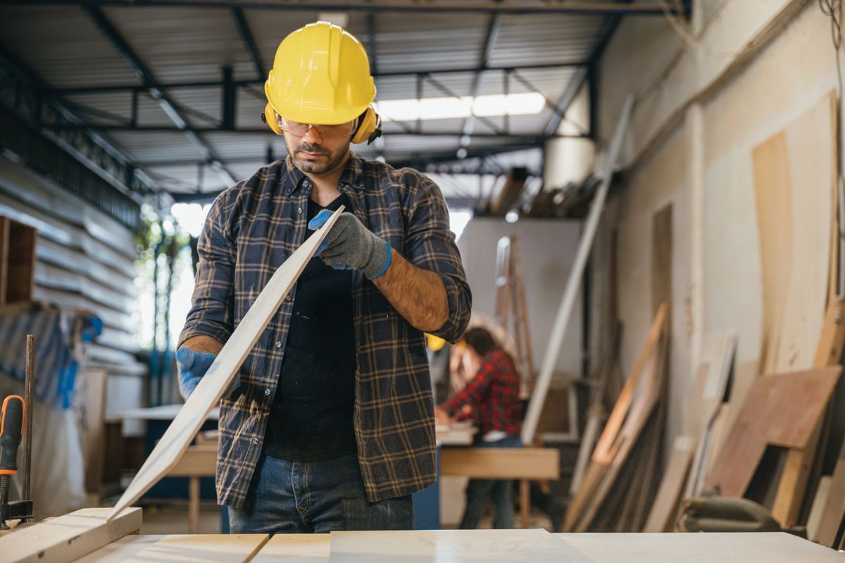 Construction,Worker,In,A,Yellow,Hardhat,And,Safety,Glasses,Inspecting