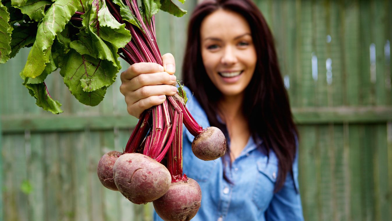 Close,Up,Portrait,Of,A,Smiling,Woman,Showing,A,Bunch